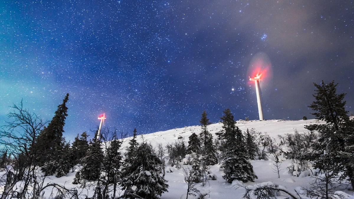 Wind generators on top of a hill beyond the arctic line in Olos, Finland